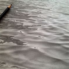 a pencil is laying on top of some water and it looks like the surface has been washed