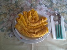 a white plate topped with food next to silverware