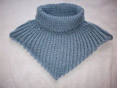 a blue knitted collar on a white blanket