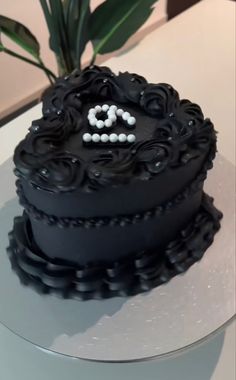 there is a black cake on the table