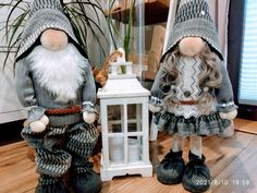 two gnomes standing next to each other in front of a mirror