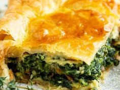 a piece of quiche with spinach and cheese