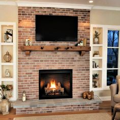 a living room with a fire place and tv above the fireplace in front of it