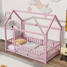 there is a pink bed with a house shaped frame on the top and bottom bunk