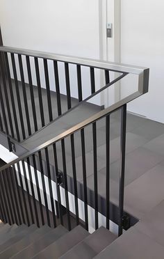 an image of a stair case with metal handrails