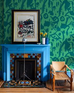 a living room with a blue fireplace and wooden chairs