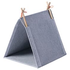 two wooden sticks sticking out of the side of a gray fabric holder with an orange handle