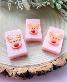 three pink soaps with reindeer faces on them