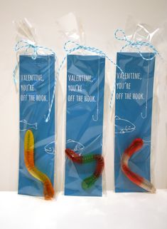 three bags with candy worms in them sitting next to each other