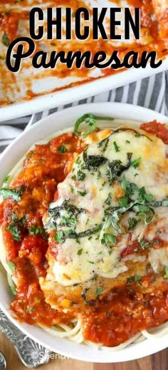 chicken parmesan with spinach and cheese in a white bowl on top of a wooden table