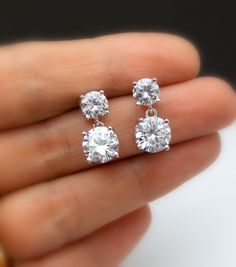 Tarnish resistant White gold plated metal framed AAA high quality clear white cubic zirconia round post earrings with AAA quality round drop clear white cubic zirconia pendant. Earring posts are surgical steel.. Size: top stone diameter: 6mm Bottom stone diameter: 8mm Matching necklace and bracelet available. https://www.etsy.com/listing/278176308/diamond-quality-solitaire-necklace-cubic?ref=listings_manager_grid https://www.etsy.com/listing/85607281/bridal-wedding-bracelet-christams?ref=shop_ho Simple Wedding Earrings, Small Earrings Gold, Diamond Charm Necklace, Round Diamond Earrings, Diamond Solitaire Earrings, Diamond Earrings Design, Solitaire Earrings, Jewelry Bridesmaid, Diamond Jewelry Designs