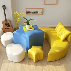 a living room filled with furniture and a guitar sitting on the floor next to it