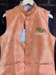 Premium quality Silk Men's Waist Coat in Peachy Pink Color with Floral Design Floral designs. Please note - there are small zari weaving that sparkles a bit. Please check the video carefully to understand the jacket well before purchase. Can be paired with a Kurta Pajama Set. Item : Men's JacketReady to Wear : YesJacket Color : Peach Fabric : Raw SilkWork : Fancy buttons, Self Deign Pattern Material Pattern : DesignerLining : Yes Measurements of the Jacket Size - 36Chest : 38 inches Length : 27 Transitional Wedding Nehru Jacket With Stand Collar, Festive Nehru Jacket With Stand Collar For Wedding, Fitted Nehru Jacket For Groom In Transitional Season, Fitted Nehru Jacket With Stand Collar For Diwali, Wedding And Festival Nehru Jacket With Stand Collar, Festive Nehru Jacket With Pallu For Groom, Nehru Jacket For Men, Wedding Kurta, Peach Fabric