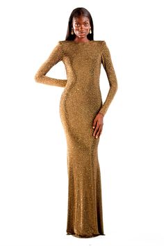 Own the night in the Valentina, a long-sleeve maxi gown that redefines glamour. This bronze masterpiece, crafted from shimmering crystalized rhinestone acetate, cascades elegantly to the floor. The semi-open back, secured by a discreet button closure, adds a touch of intrigue, while the range of sizes ensures a perfect fit for every fashion-forward form. This is more than a dress, it's an unforgettable entrance. Luxury Long Sleeve Gold Gown, Luxury Gold Gown With Long Sleeves, Gold Long-sleeve Evening Dress For Gala, Gold Long Sleeve Gala Evening Dress, Gold Long Sleeve Evening Dress For Gala, Glamorous Sparkling Evening Maxi Dress, Luxury Long Sleeve Gala Gown, Luxury Long Sleeve Gown For Gala, Gold Long Sleeve Gala Gown