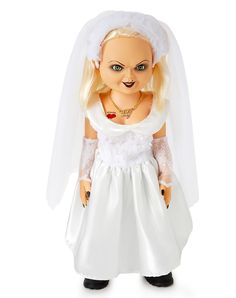 a doll dressed in a white wedding dress and veil is standing on a white background