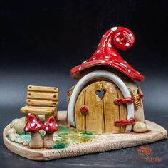 a red and white gnome's house with mushrooms on it