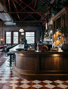 a bar with checkered flooring and brick walls