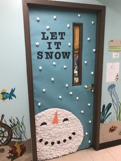 a door decorated to look like a snowman with the words let it snow on it