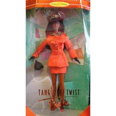 the barbie doll is wearing an orange dress and hat