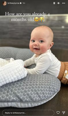 a baby laying on top of a pillow with the caption how are you already 4 months old?