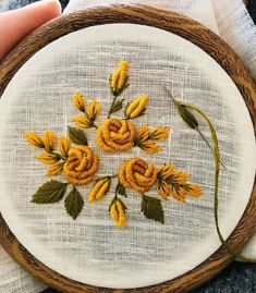 hand embroidered yellow flowers in a wooden bowl