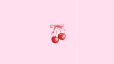 two cherries hanging from a pink ribbon