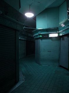 an empty storage room with the door open and lights on in the dark above it