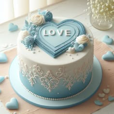 a blue and white cake with the word love on it