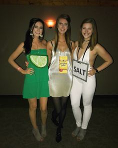 three beautiful women standing next to each other in front of a wall with a sale sign on it