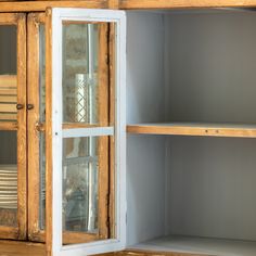 a wooden cabinet with glass doors and shelves