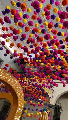 the ceiling is decorated with colorful pom - poms hanging from it's rafters