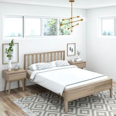 a bedroom with white walls and wood floors