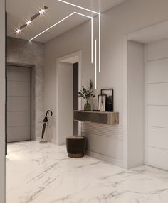 a white room with marble flooring and lights hanging from the ceiling, along with an open door