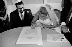 a bride and groom signing their marriage vows