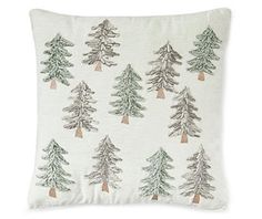 a white pillow with pine trees on it