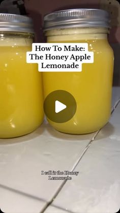 two jars filled with lemonade sitting on top of a white tile counter next to the words how to make the honey apple lemonade