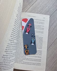 an open book with cars on it and the pages are folded in half to form a rectangle