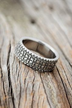 a silver ring sitting on top of a wooden table