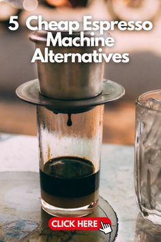 a coffee maker sitting on top of a table next to a glass filled with liquid