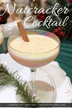 a drink in a coupe glass with a cinnamon stick sticking out of it and the words, nutcracker cocktail