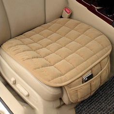 the inside of a car with a dog bed in it's back seat area