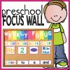 a poster with the words preschool focus wall written on it and a boy holding a board