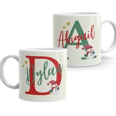 two white coffee mugs with christmas designs on them