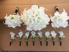 wedding bouquets and boutonnieres laid out on a cardboard box