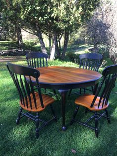 a table and four chairs sitting in the grass