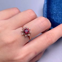 925 Sterling Silver Ring, Natural Garnet Red Stone Halo Ring, Ring for Women, Birthstone Ring for Women, Dainty Stackable Ring, Gift for Her. BASIC INFORMATION Gemstone: Natural Garnet Raw Stone Size: Round 6mm Dainty CZ Diamond (shining zircon). Side stones: Shining CZ diamond (cubic zircon). Band color: Silver--18K white gold plated sterling silver Rose Gold--18K rose gold plated sterling silver Gold -- 18K yellow gold plated sterling silver CUSTOM METALS Ring Size: From US #2 to US #15. Suppl Rose Gold Ruby Cluster Ring With Gemstones, Rose Gold Garnet Gemstone Ring, Ruby Cluster Ring In Rose Gold As Gift, Gift Ruby Cluster Ring In Rose Gold, Rose Gold Ruby Cluster Ring Gift, Burgundy Gemstone Wedding Rings, Rose Gold Garnet Rings For Gift, Fine Jewelry Ruby Ring In Burgundy For Gift, Fine Jewelry Burgundy Ruby Ring Gift