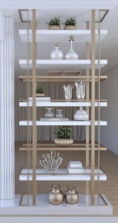 the shelves are filled with vases and other decorative items in white and gold colors