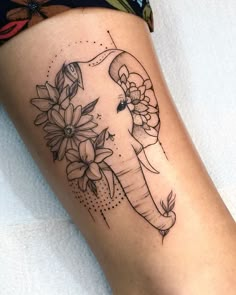 an elephant with flowers on it's leg