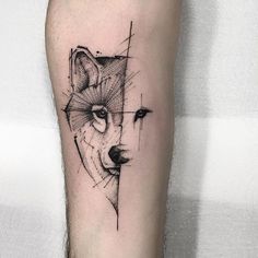 a tattoo on the leg of a man with a wolf's head