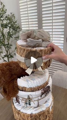 a person is holding a teddy bear in front of a stack of diapers